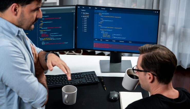 Photo it developers discussing online software development information on pc screen creating program coding for latest version application on website concept of brainstorming firmware updated sellable