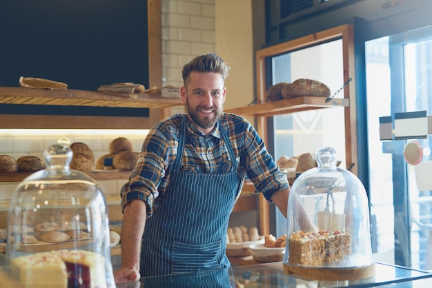 It doesnt get fresher than this Portrait of a young business owner standing behind the counter in his bakery