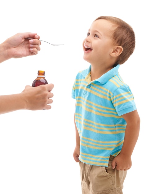 It doesnt taste so bad Studio shot of a happy young boy being given some medicine on a spoon by his mother