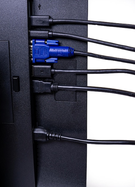 It engineer man hand inserts cable into monitor man hand\
connecting the dvi cable for monitor to computer pc vga dvi\
displayport and power cable close up in the hands of an\
isolated