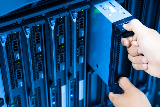 IT engineer repairing a server in a datacenter