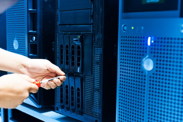 IT engineer repairing a server in a datacenter