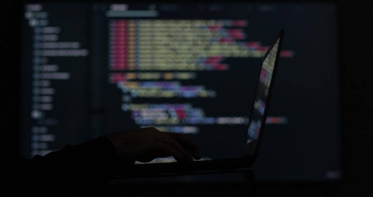 Photo it engineer software developer programmer interacts with a chatbot by creating code face hacking system hacker attack concept