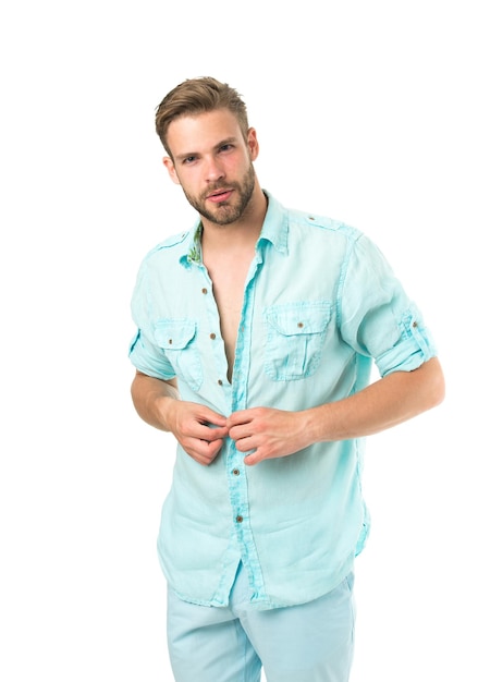 It is hot here. Man handsome bearded guy undressing white background isolated. Guy confident attractive macho feels sexy while unbuttoning shirt. I will show you my sexy body. Want to see sexy torso.