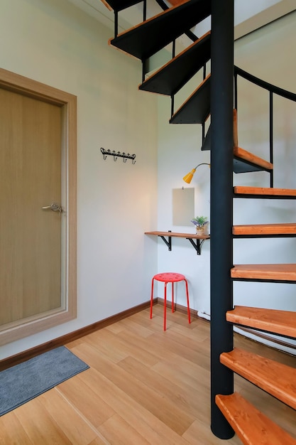 It is an image of an Airbnb accommodation or a house with an attic going up the spiral staircase