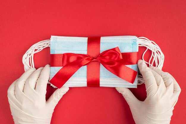 It is time to share presents concept. Top above pov first person overhead close up view photo of hands in protective latex gloves preparing surprise isolated bright background