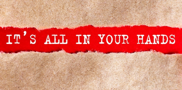 IT'S ALL IN YOUR HANDS word written under torn paper on red background, business