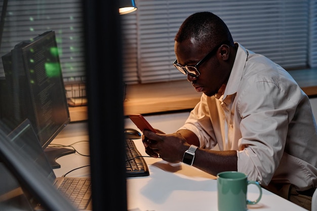 IT specialist working online on smartphone