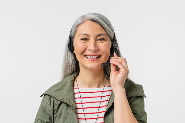 IT support manager hotline worker help line Caucasian mature middleaged woman in headset assisting helping client customer isolated in white background