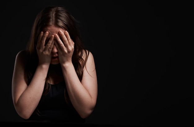 It was terrible. Shot of a woman standing with her hands over her face.