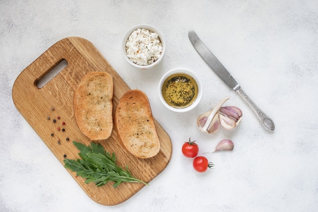 Italiaanse bruschetta met geroosterde tomaten, mozzarellakaas en kruiden op een snijplank.