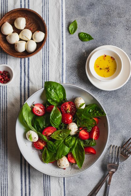 Italiaanse caprese salade met gesneden tomaten, mozzarella, basilicum, olijfolie