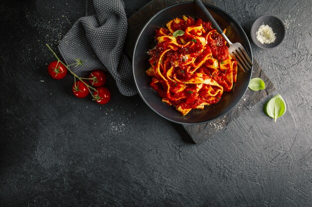 Italiaanse spaghetti met tomatensaus die op plaat wordt gediend