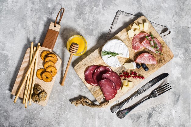 Italian antipasto with prosciutto, salami, Parmesan, brie and Gorgonzola cheese, honey.