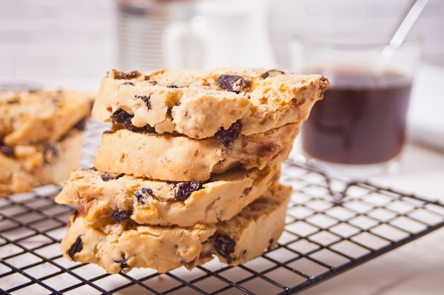 Italian biscotti on the baking rack and glass of coffee on the surface