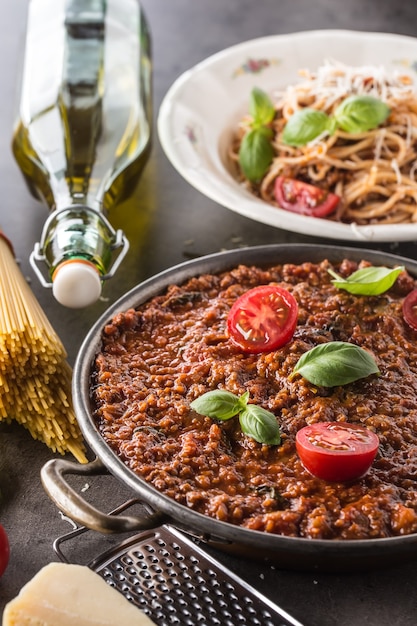 Italian bolognese sauce with pasta spaghetti olive oil tomatoes basil and parmesan cheese
