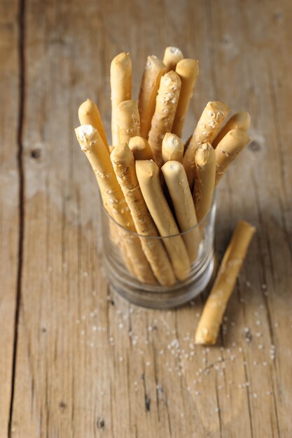 Italian bread sticks in a glass on a table