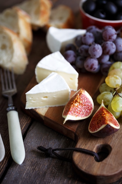 Italian breakfast - grapes, brie cheese, salami, figs and olives