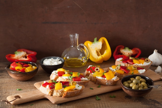 Italian bruschetta with roasted peppers goat cheese olives