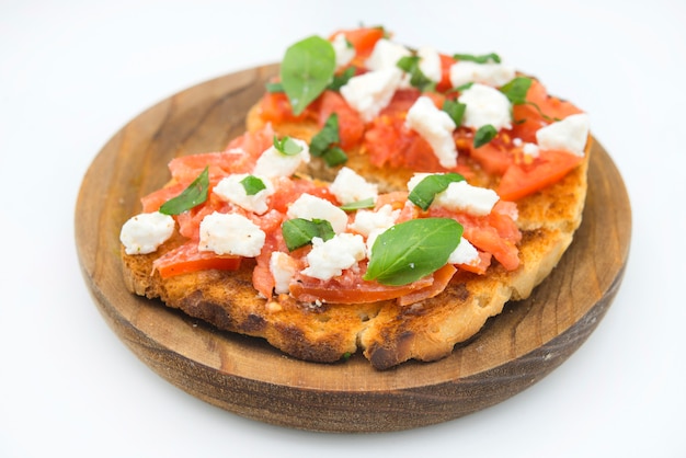 Italian bruschetta with tomatoes mozzarella cheese and basil