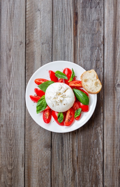 Italian burrata cheese with tomatoes and basil. Salad. Healthy eating. Vegetarian food.