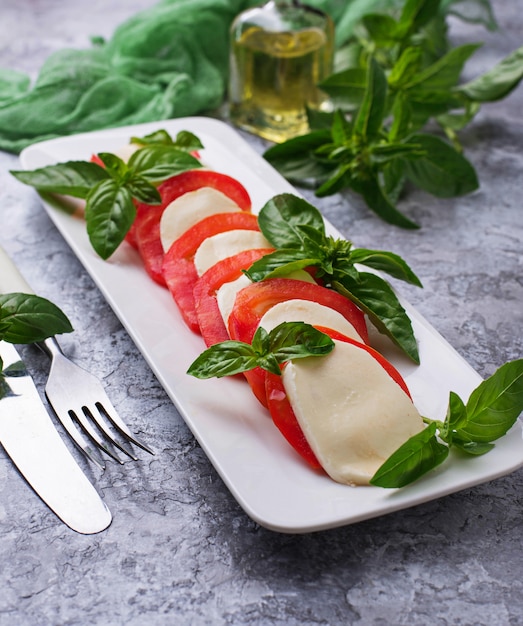 Italian caprese salad with mozzarella, tomatoes and basil. Selective focus