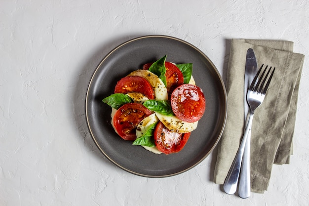 Italian caprese salad with mozzarella and tomatoes. White. Healthy food.