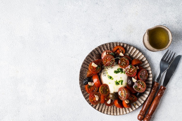 Italian caprese salad with sliced tomatoes mozzarella basil olive oil on a light background Top view Healthy food Italian salad