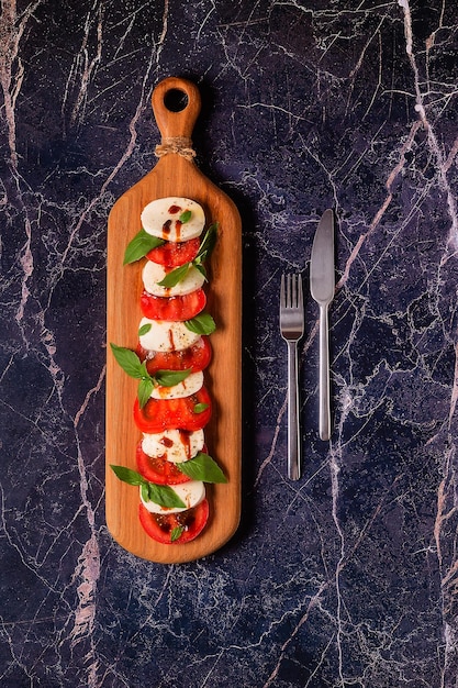 Italian caprese salad with sliced tomatoes mozzarella basil olive oil