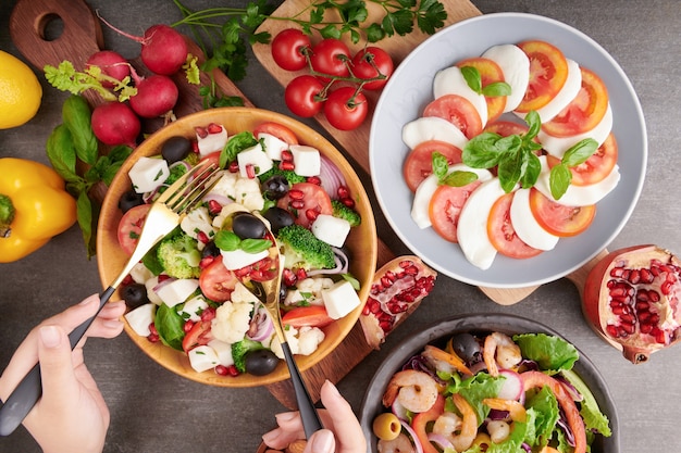 Italian caprese Salad with tomatoes, basil, mozzarella, olives and olive oil. Italian traditional caprese salad ingredients. Mediterranean, Greek salad, Shrimp Salad.organic and natural food concept.