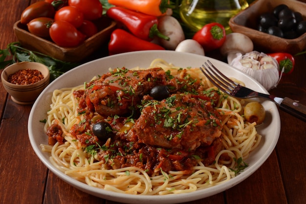 Italian chicken Cacciatore hunter's stew with spaghetti noodles