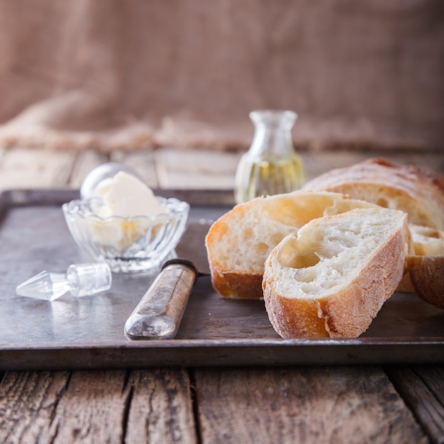 Italian ciabatta bread cut in slices on chopping board