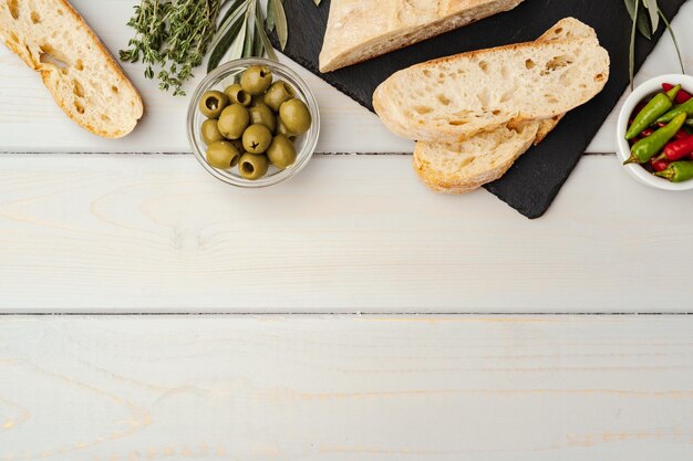 Italian ciabatta bread with olive oil on wooden background