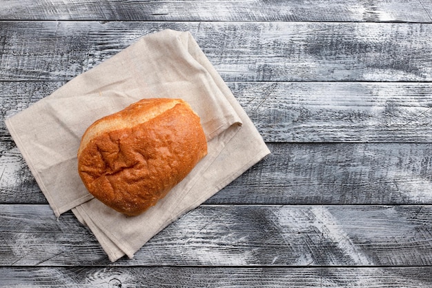 Italian ciabatta on a white wooden background top view