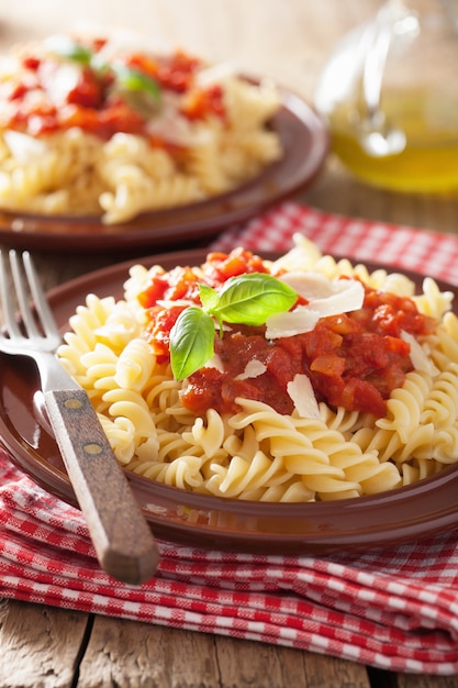 Italian classic pasta fusilli with tomato sauce and basil