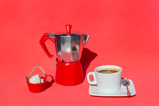 Italian coffee maker, cup and saucer of hot drink