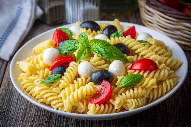 Italian cold pasta salad or Pasta fredda alla caprese. Directly above. Fusilli, tomato, mozzarella, olive, arugula. Turkish name; burgu makarna salatasi