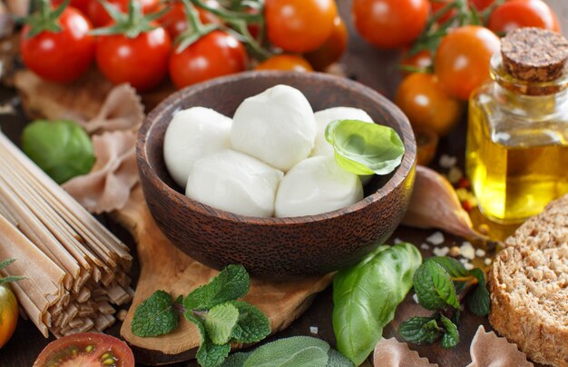 Italian cooking ingridients : mozzarella, tomatoes, basil,  olive oil and other