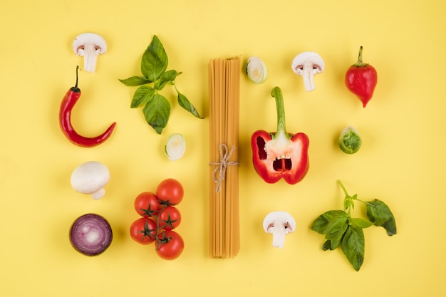 Italian cuisine concept, set of ingredients, pasta, tomatoes, peppers, mushrooms, basil