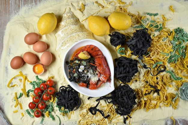 Italian cuisine dish Fettuccine with cuttlefish ink and crayfish in a white plate