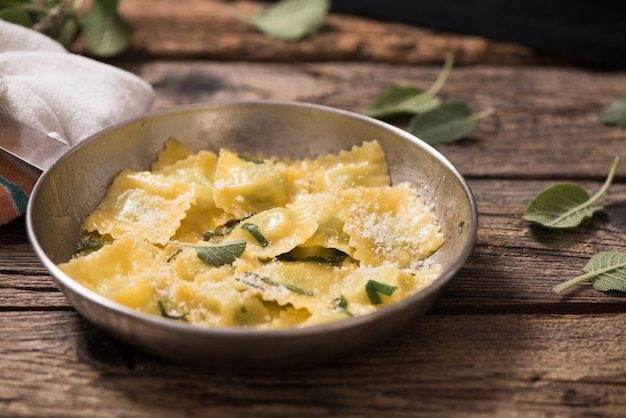 Italian cuisine ravioli pasta with parmesan cheese and sage