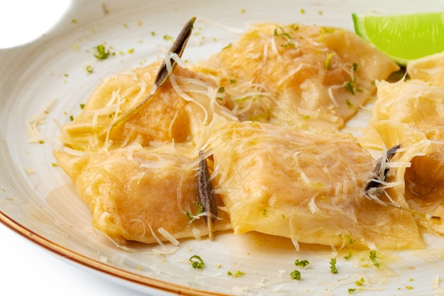 Italian dish ravioli with parmesan in a plate