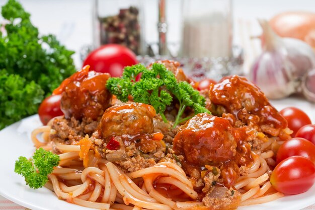 Italian dish spaghetti bolognese with beef meatballs and parsley