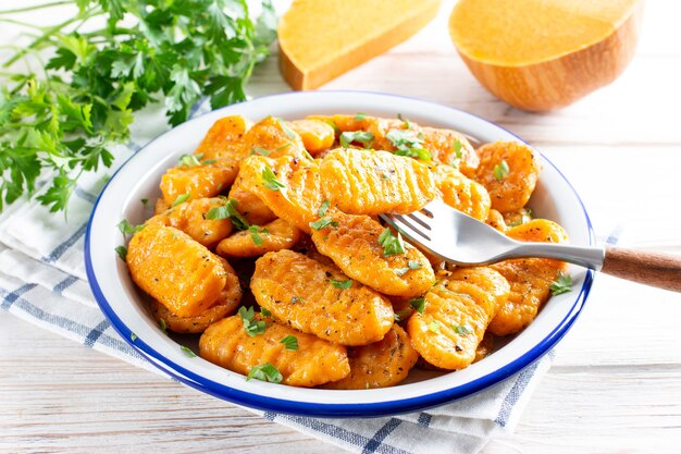 Italian dumplings. Pumpkin gnocchi. Healthy vegetarian squash dish on the plate