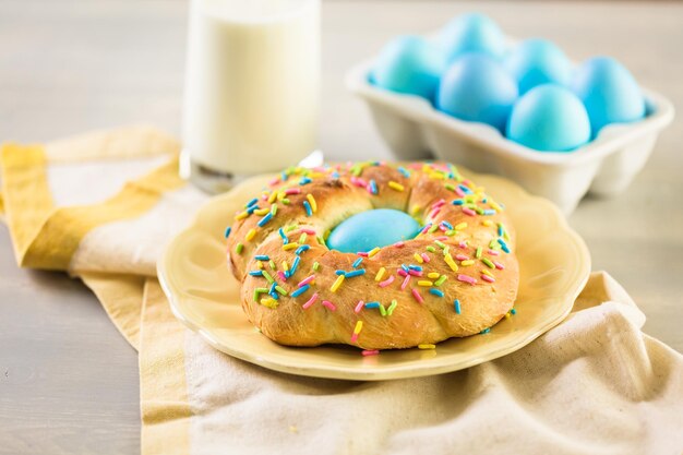 Italian Easter bread with blue colored egg and sprinkles.