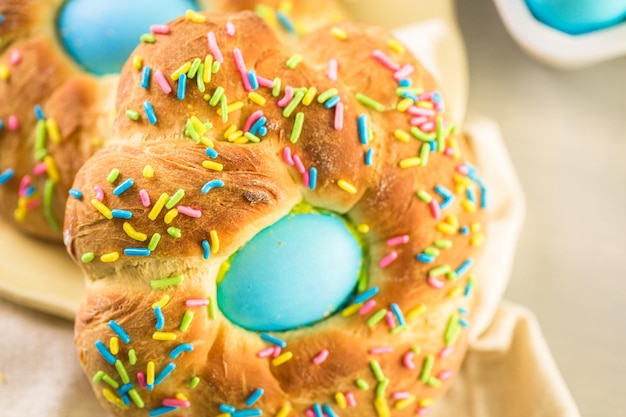 Italian Easter bread with blue colored egg and sprinkles.