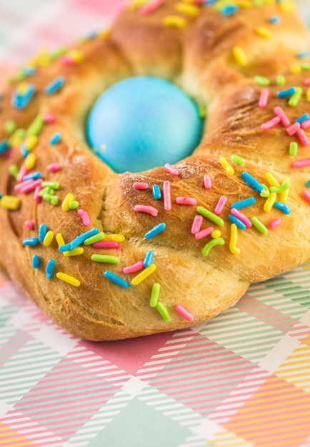 Italian Easter bread with blue colored egg and sprinkles.