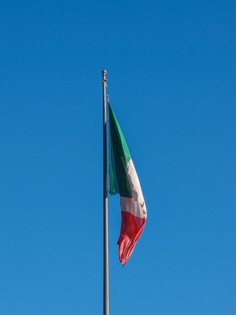 Italian flag over blue sky