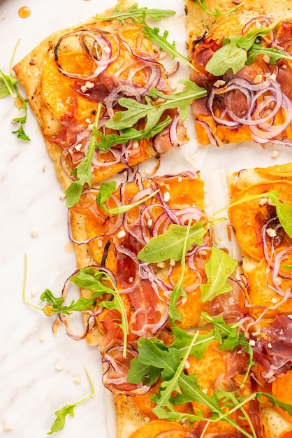 Italian focaccia or flat bread with onion and rocket salad