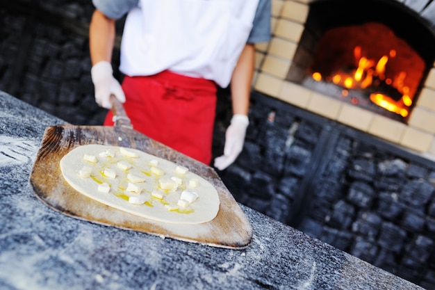 Italian focaccia with olive oil and cheese in the oven